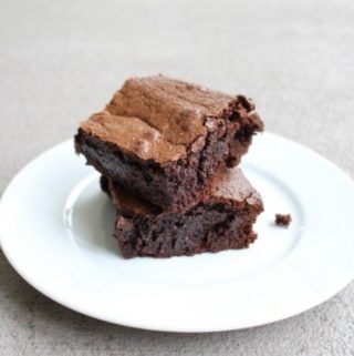 Deep dish brownies on a white plate