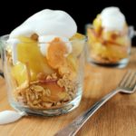 Sautéed apples in a touch of butter and brown sugar are topped with granola and cinnamon whipped cream. Perfect for a light dessert or snack!
