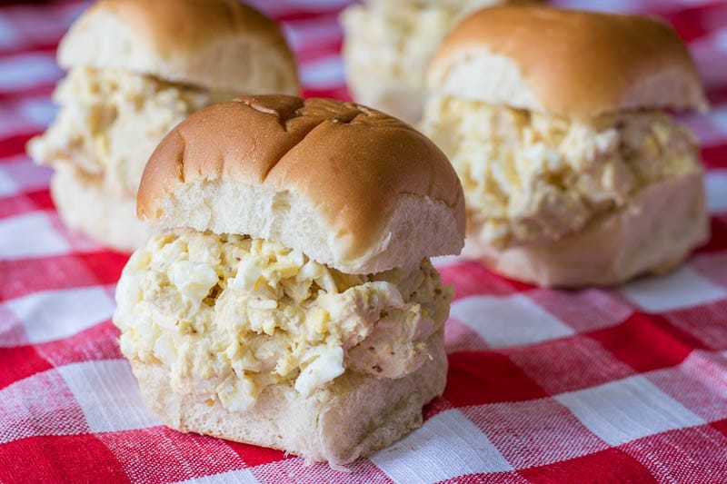 Four Southern Chicken Salad Sandwiches on a picnic tablecloth