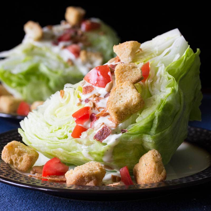This classic wedge salad recipe is made with crisp iceberg lettuce, crumbly bacon, creamy dressing, and more. You'll love the delicious flavor and texture!