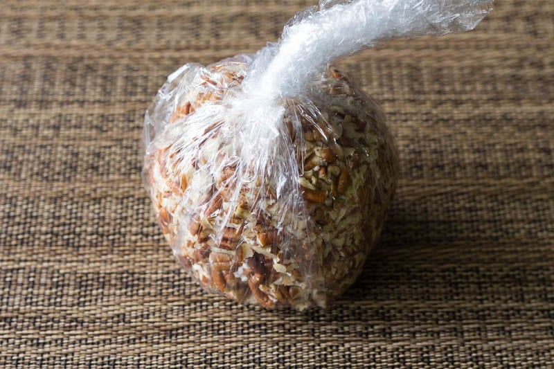 Whip up this easy cheese ball recipe in minutes, using cream cheese, cheddar, and pecans. You'll also get my handy trick for packing up cheese balls to go!