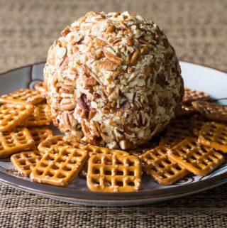 Whip up this easy cheese ball recipe in minutes, using cream cheese, cheddar, and pecans. You'll also get my handy trick for packing up cheese balls to go!