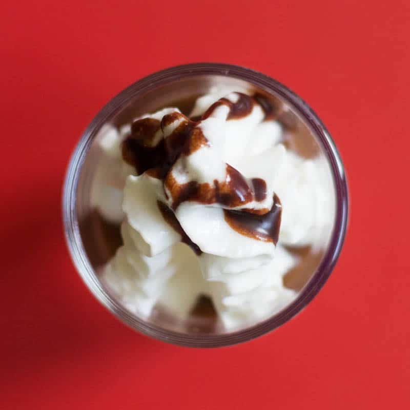 Make dessert shooters just like a fancy coffee drink with a simple combination of coffee pudding, whipped cream, and chocolate syrup. Easy and delicious!