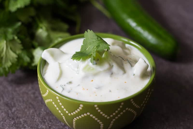 This cucumber raita recipe is made with whole milk yogurt, cumin, cilantro and seedless cucumbers. A perfectly cool and refreshing dip!