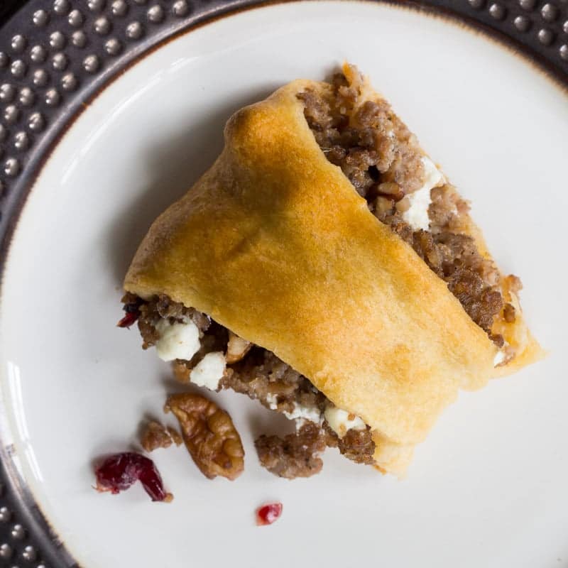 Crescent roll ring stuffed with crumbled pork sausage, cranberries, pecans, and goat cheese. A perfect appetizer or party platter!