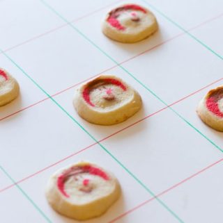 Use Christmas cookies to make an edible checkers set! This step-by-step recipe shows you how to make fun Christmas cookie checkers for the holidays.