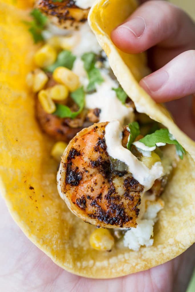 Spicy shrimp tacos are even better on toasted corn tortillas! Add your own toppings and finish it off with a fiery sour cream.