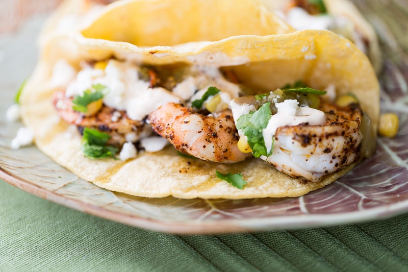 Spicy shrimp tacos are even better on toasted corn tortillas! Add your own toppings and finish it off with a fiery sour cream.