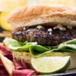 Carne Asada Mexican Burger with chips and a lime