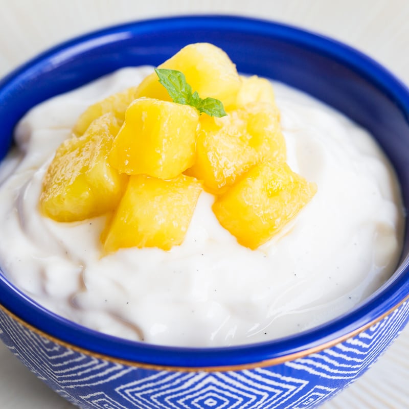 Fresh Pineapple Topping on yogurt in a blue bowl