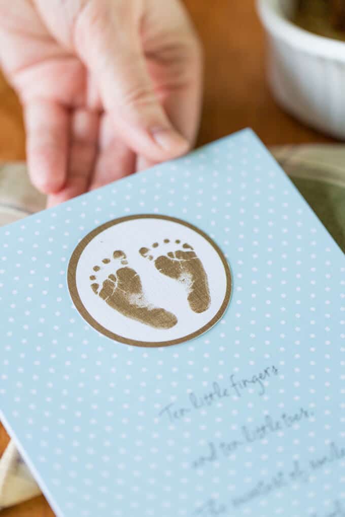 Woman's hand holding a baby card