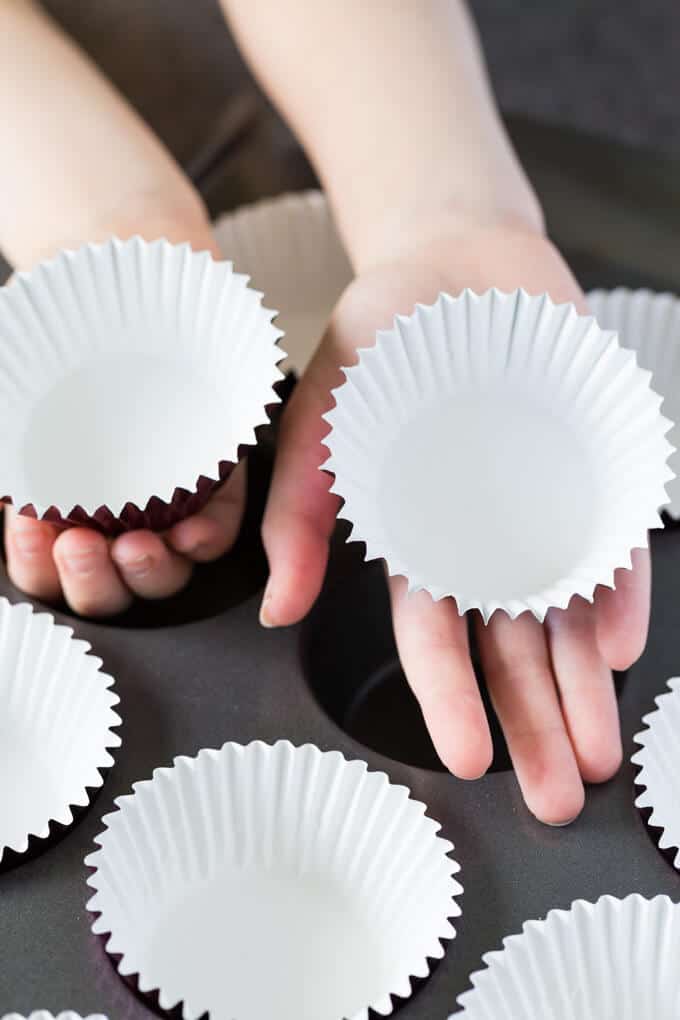 Baking with kids - Children's hands holding cupcake liners