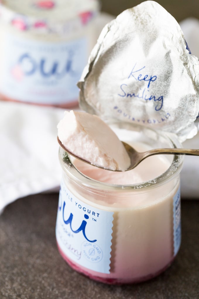 Spoonful of French yogurt from a glass jar