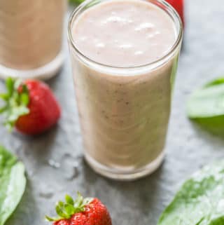 PBJ Spinach Banana Smoothie with spinach leaves and whole strawberries