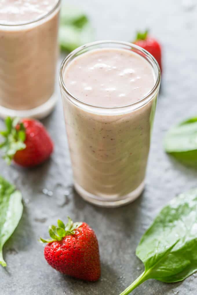 PBJ Spinach Banana Smoothie with spinach leaves and whole strawberries