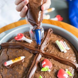 Decorating a brownie with chocolate frosting pastry bag