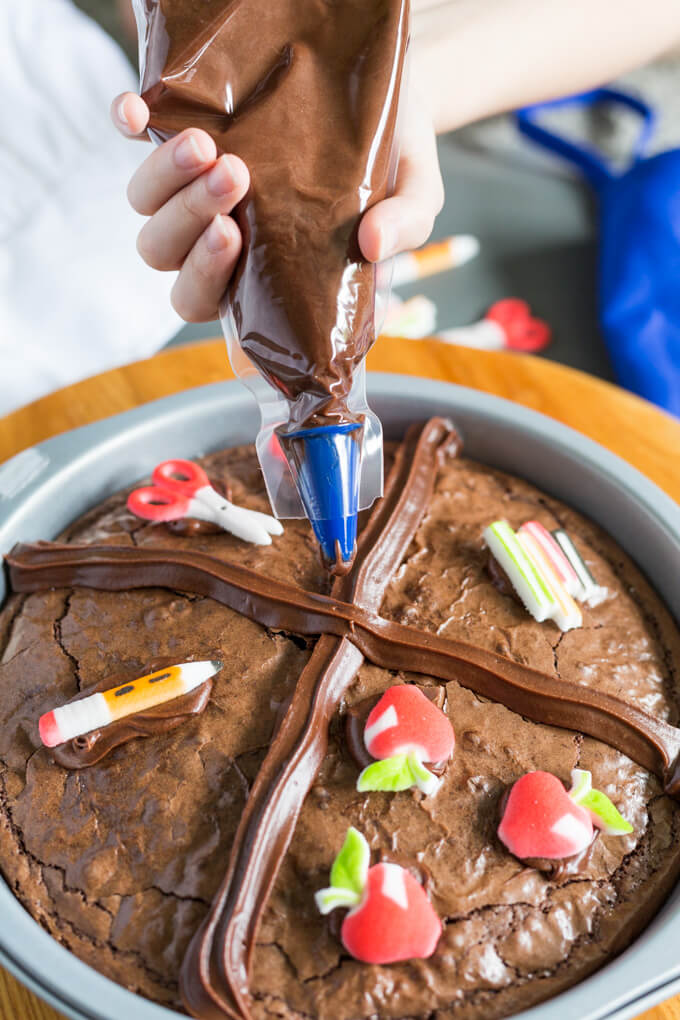 Decorating a brownie with chocolate frosting pastry bag