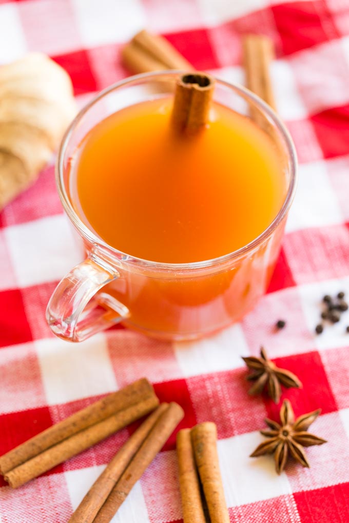 Chai Spiced Hot Apple Cider Tea with a cinnamon stick garnish