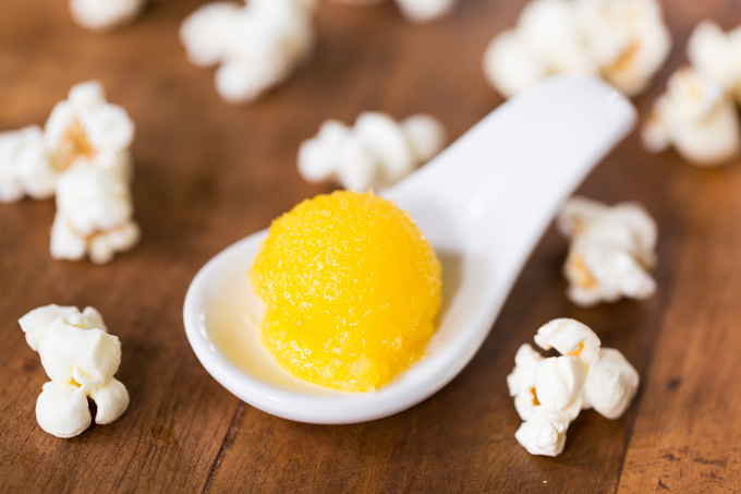 Ghee in a porcelain spoon with popcorn
