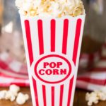 Popcorn in a red striped popcorn bucket