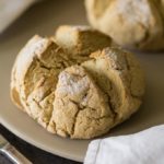 Two round loaves of gluten free irish soda bread on a baking stone