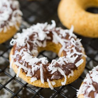 Wire rack of baked gluten free doughnuts