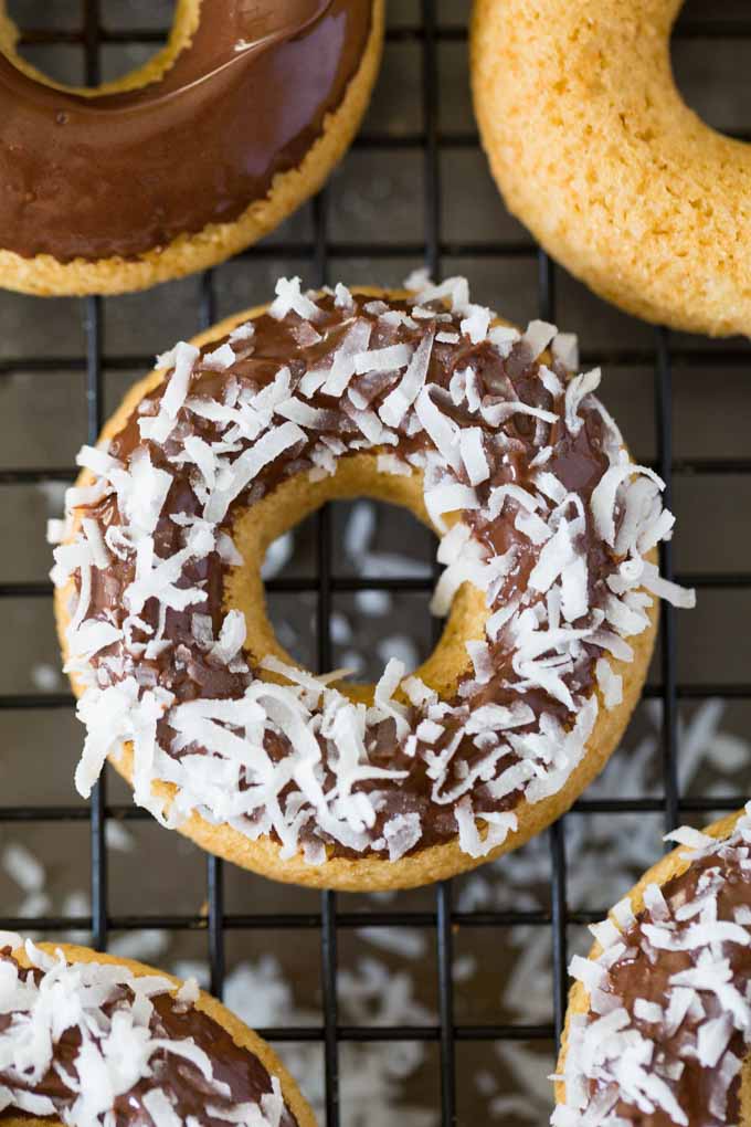 Gluten Free Doughnuts with coconut and chocolate on a wire cooling rack