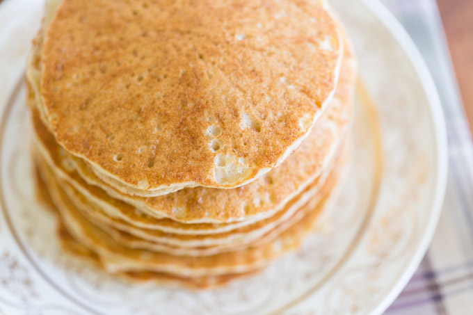 Stack of Gluten free Sorghum pancakes on a plate on a wood table