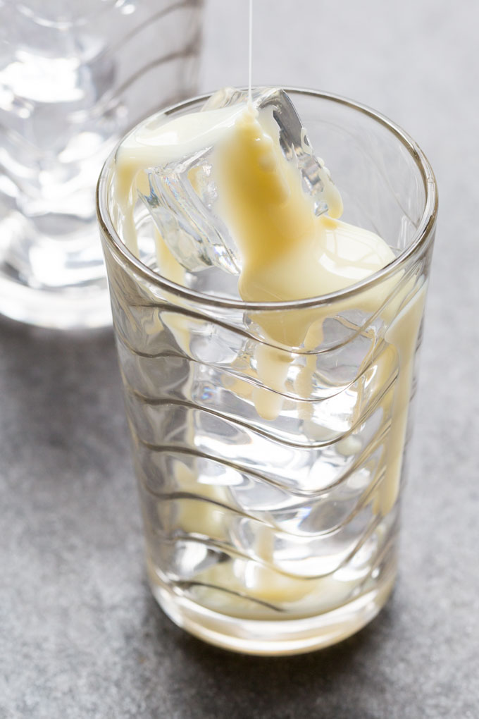 Clear glass with ice and sweetened condensed milk