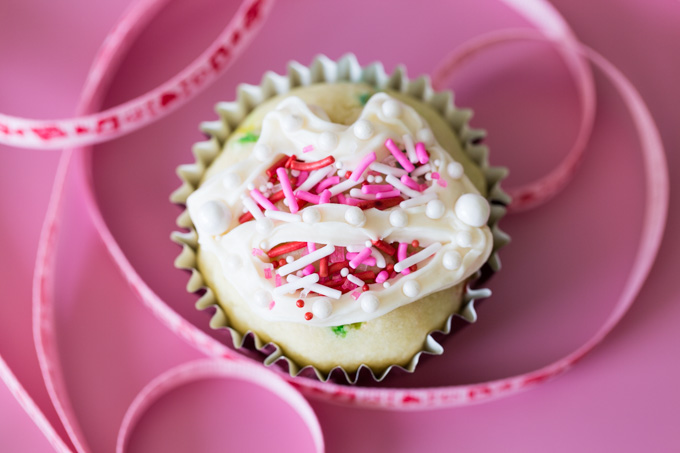 A valentine cupcake with a lip shaped frosting design