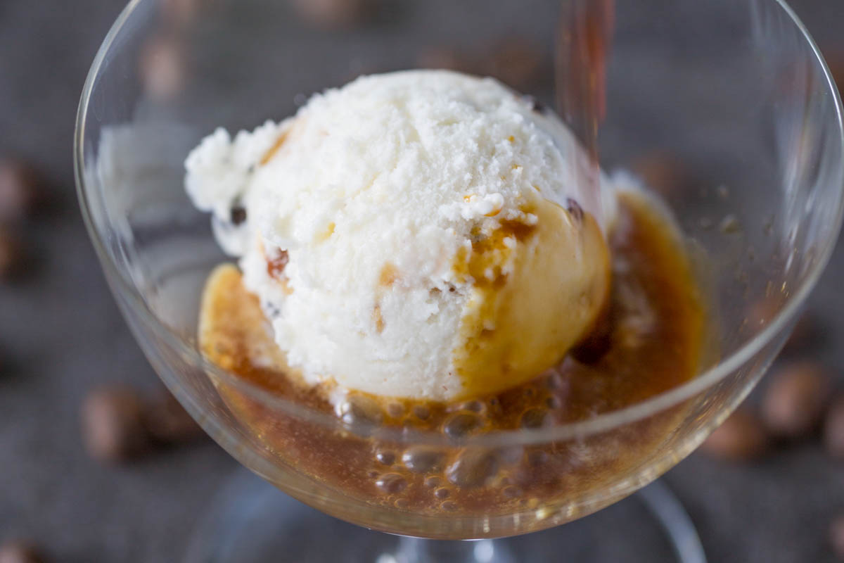 Pouring coffee over ice cream in an affogato glass