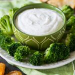 Bowl of Greek yogurt dip for veggies and chips shown with broccoli and BBQ chips