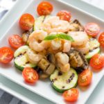 Italian shrimp and vegetables on a white square plate
