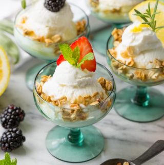 Fruit and Herb Yogurt Bar with cups of yogurt on marble counter