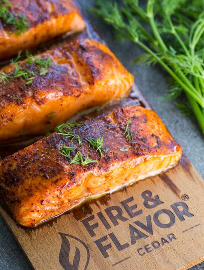 Cedar plank oven salmon on a plank with fresh dill garnish