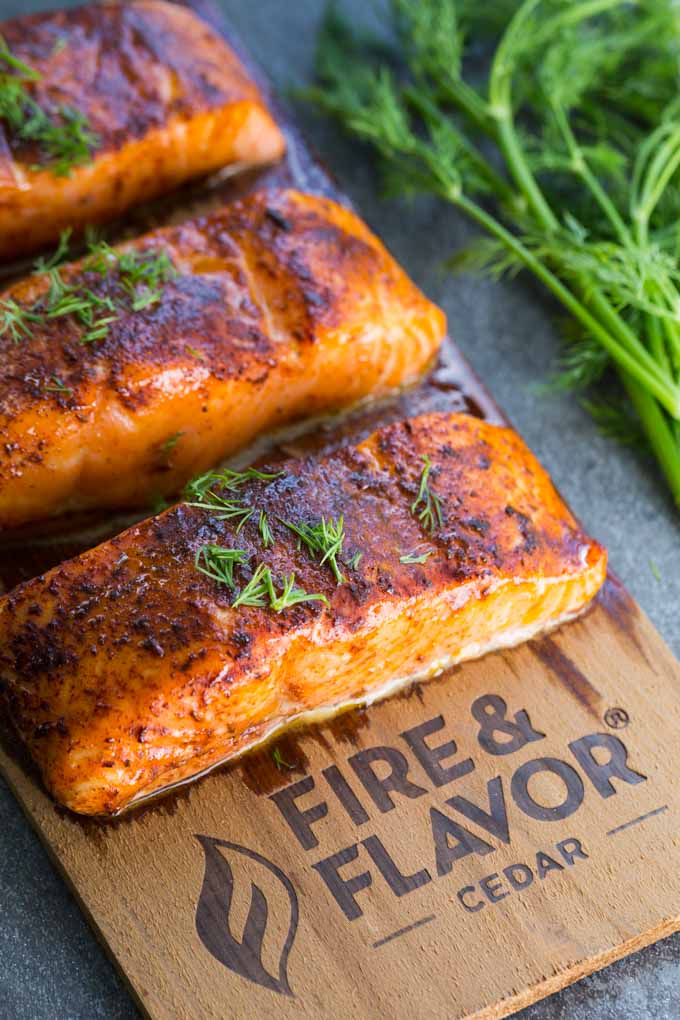 Cedar plank oven salmon on a plank with fresh dill garnish