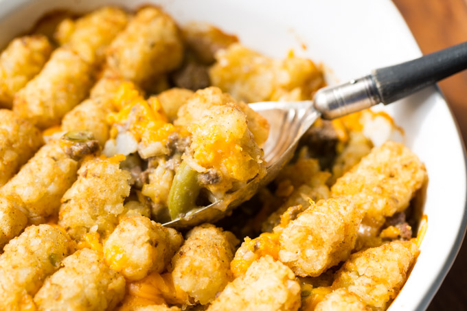 Tater tot hotdish with a serving spoon