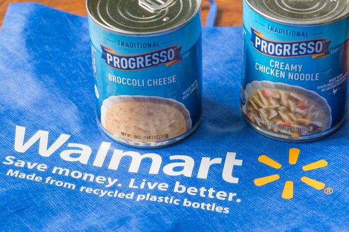 Two cans of Progresso soup on a Walmart bag