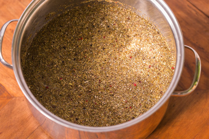 Turkey brine solution with herbs, salt, and sugar in a large pot