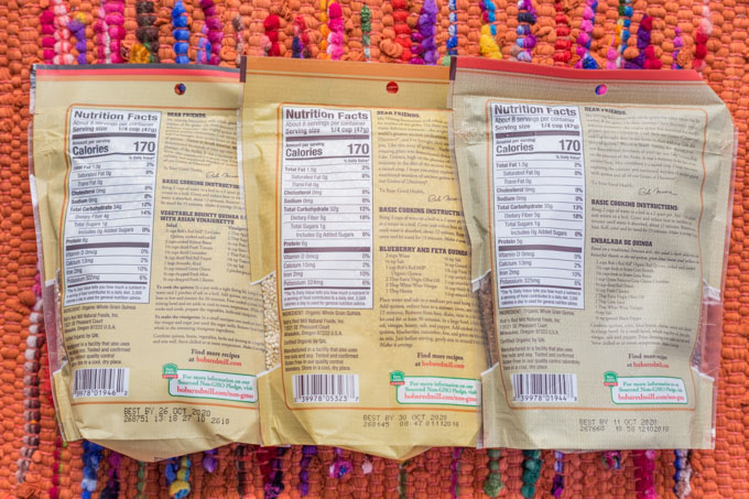 Nutrition labels on the back of three bags of quinoa