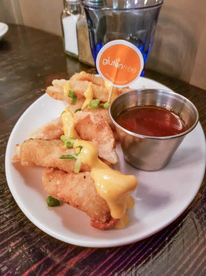 Vegetable potstickers with dipping sauce on a white plate