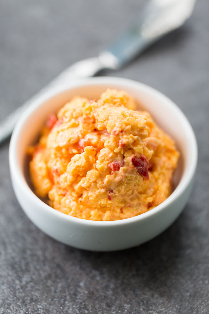 Scoop of hatch chile pimento cheese in a white bowl