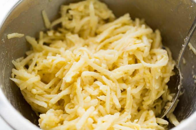 Potato latke ingredients in a mixing bowl