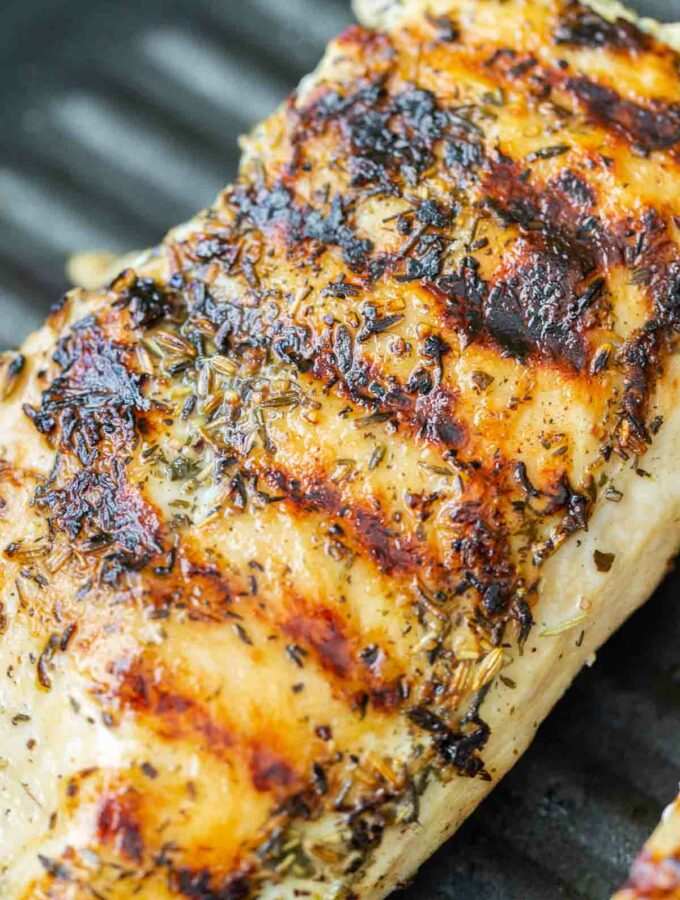 Cooked brined chicken breasts with sear marks in a grill pan